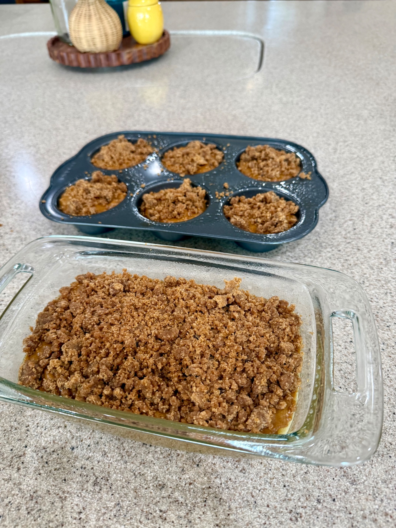 Banana pumpkin loaf and muffins topped with cinnamon crumble before baking.