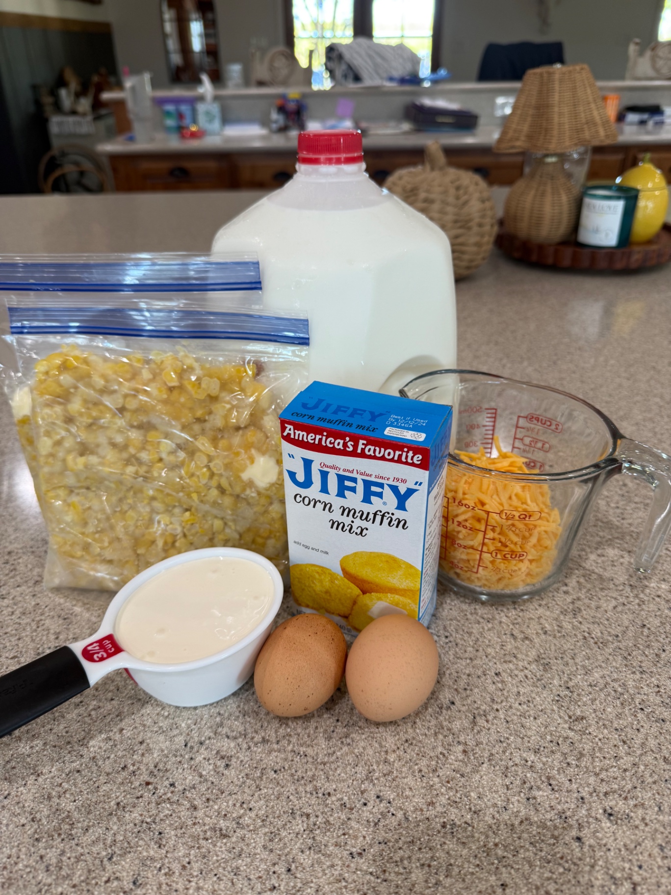 The supplied ingredient lineup for corn casserole, including corn, Jiffy Corn Muffin Mix, crema, eggs, and cheddar.