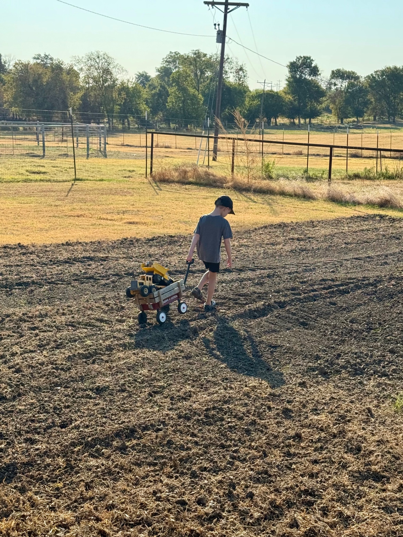 Our son pulling a wagon across the freshly tilled garden after the end-of-summer reset