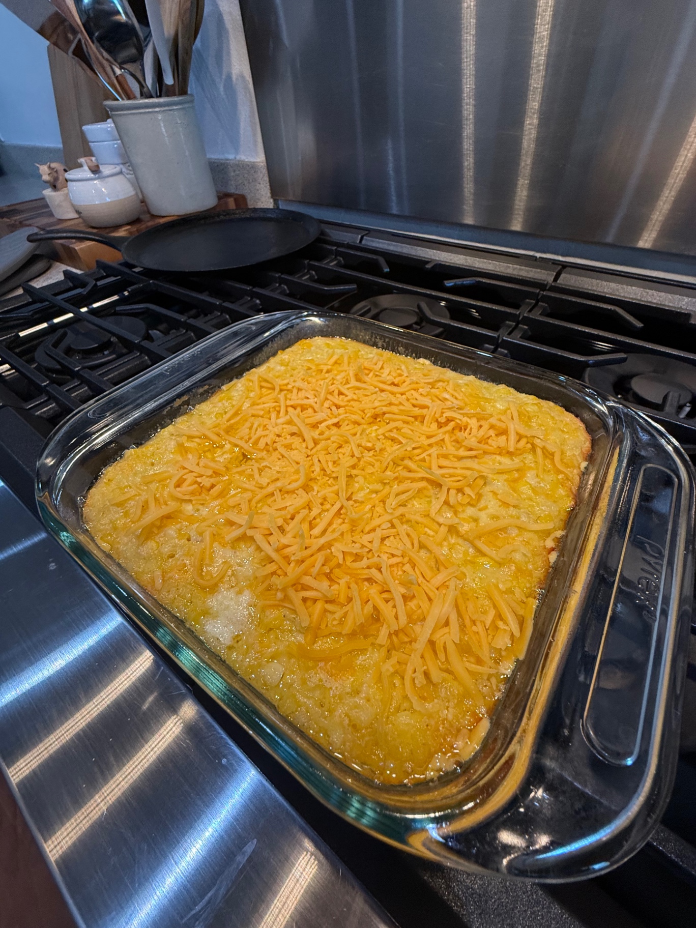 Corn casserole topped with the final 1/4 cup shredded cheddar before the last bake.