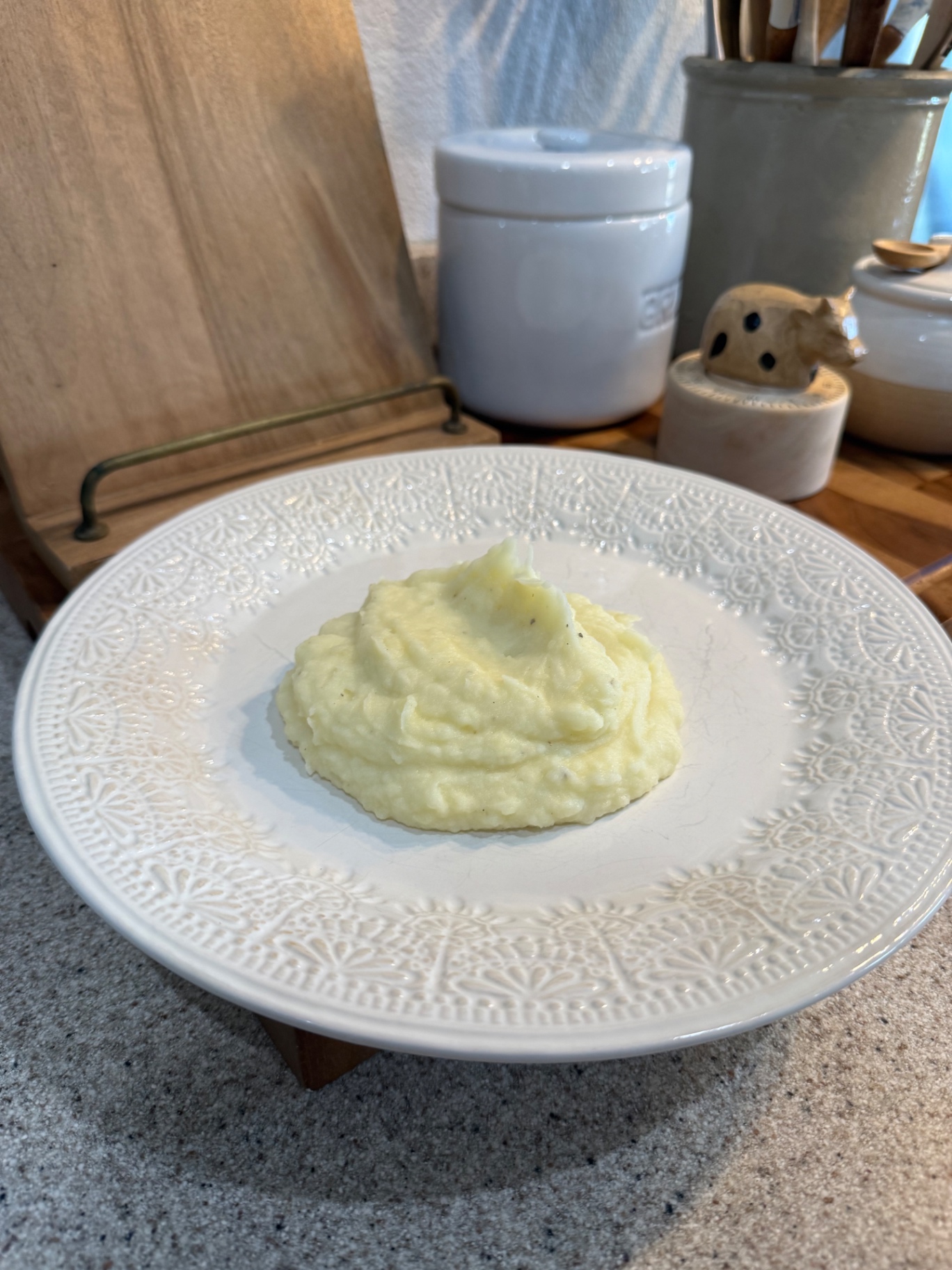 Creamy Yukon Gold mashed potatoes served on a white patterned plate in the Pasture Threads kitchen.