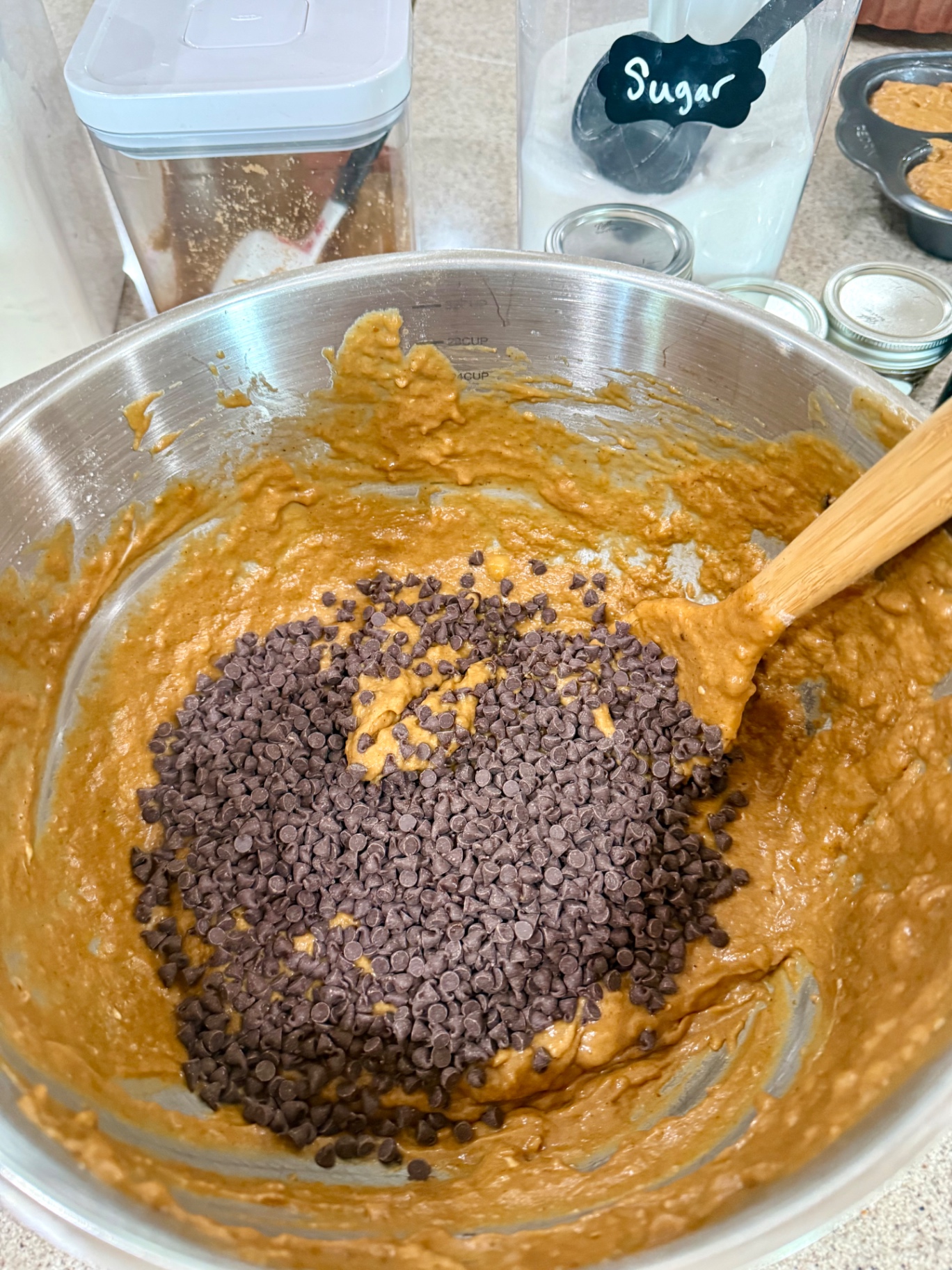 Mini chocolate chips added to banana pumpkin muffin batter.