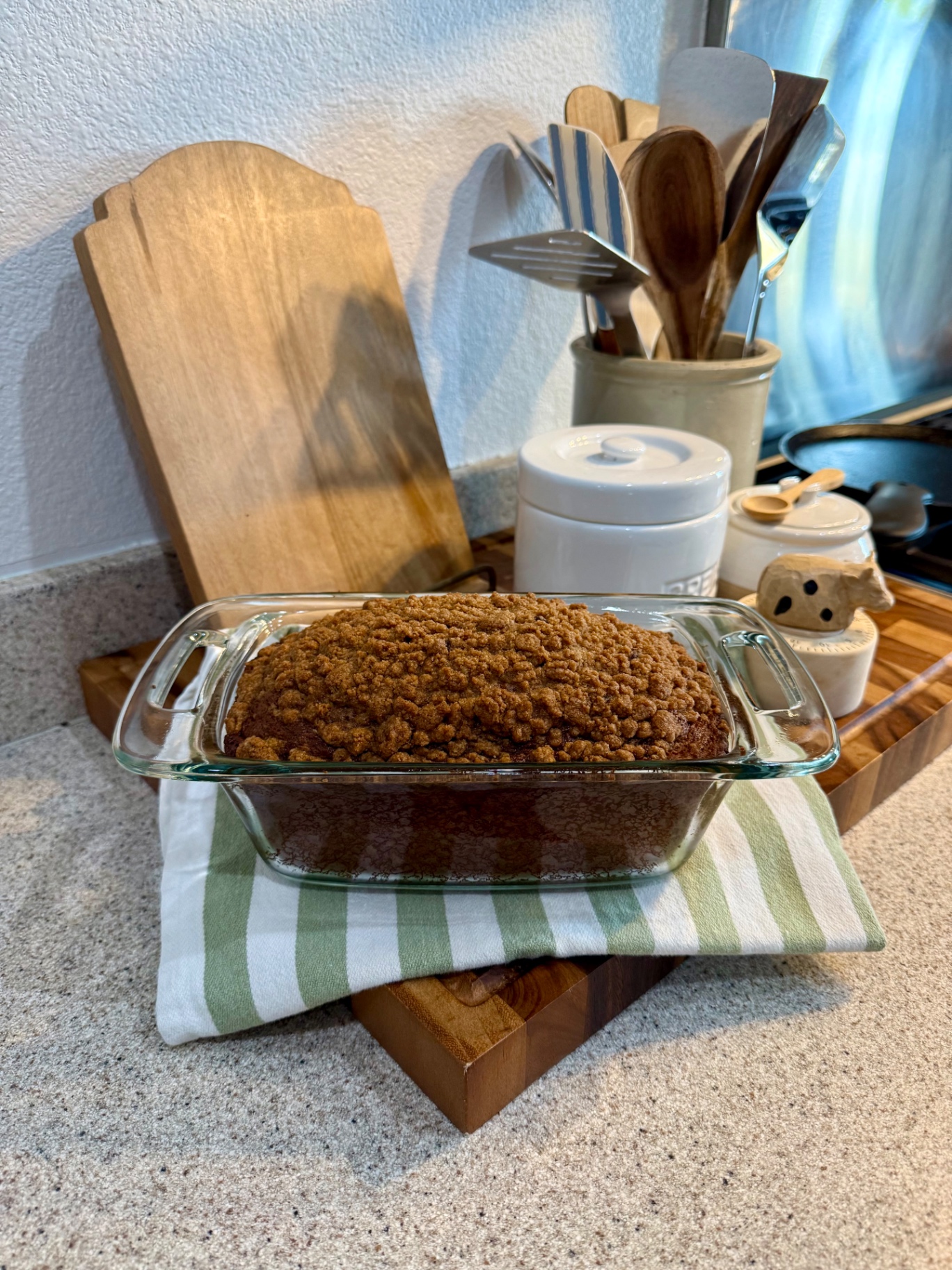 Finished banana pumpkin bread topped with cinnamon crumble in a glass loaf pan.
