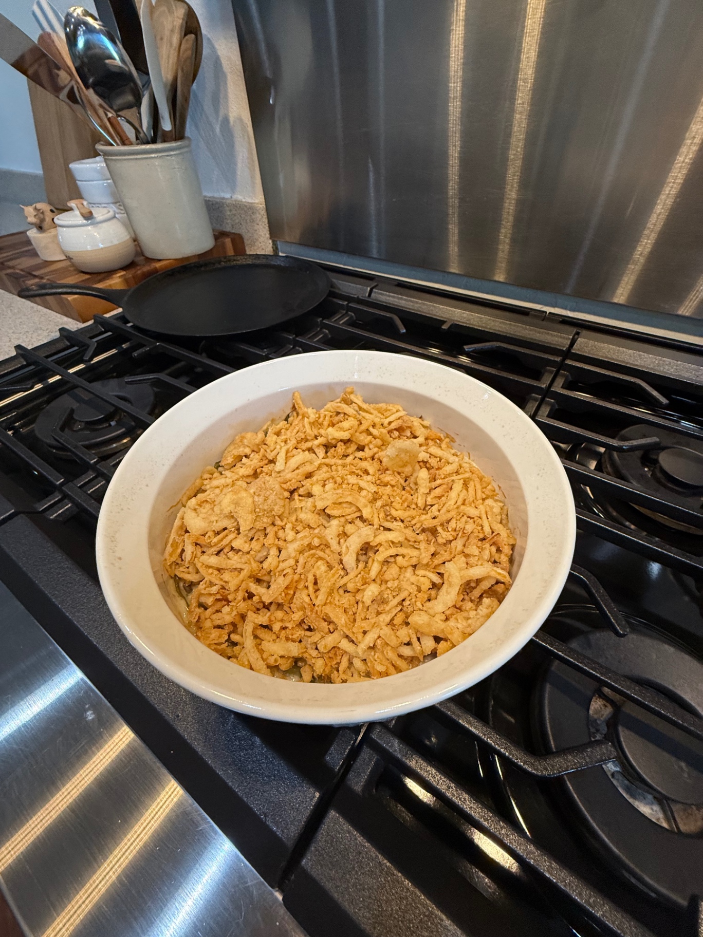 Green bean casserole topped with crispy fried onions before the final 10-minute bake.