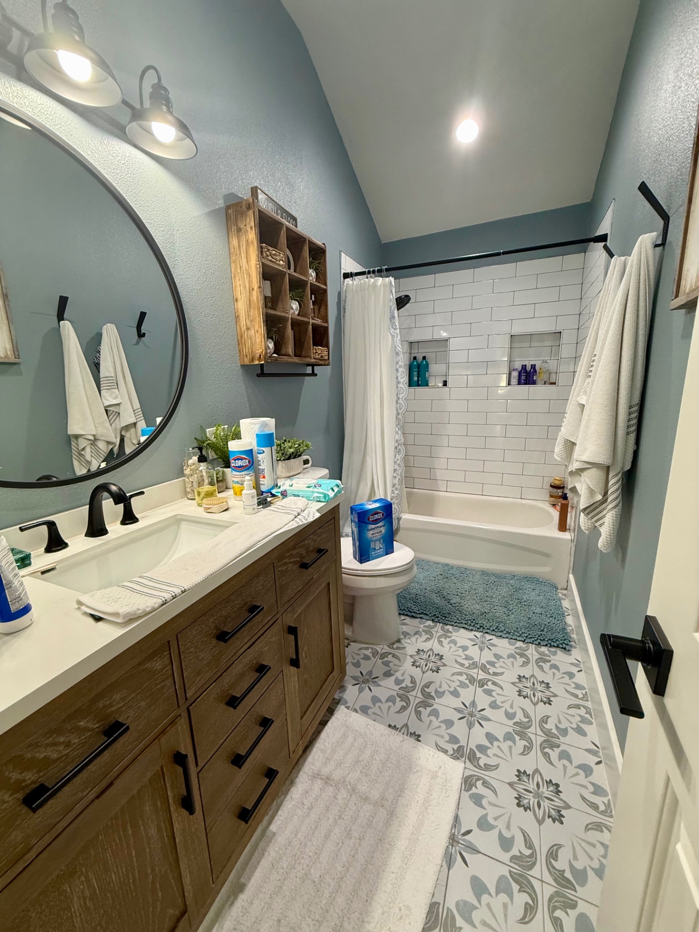 Bathroom counter with cleaning products set out before cleaning